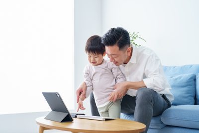 Parent and child hitting the keyboard on the table